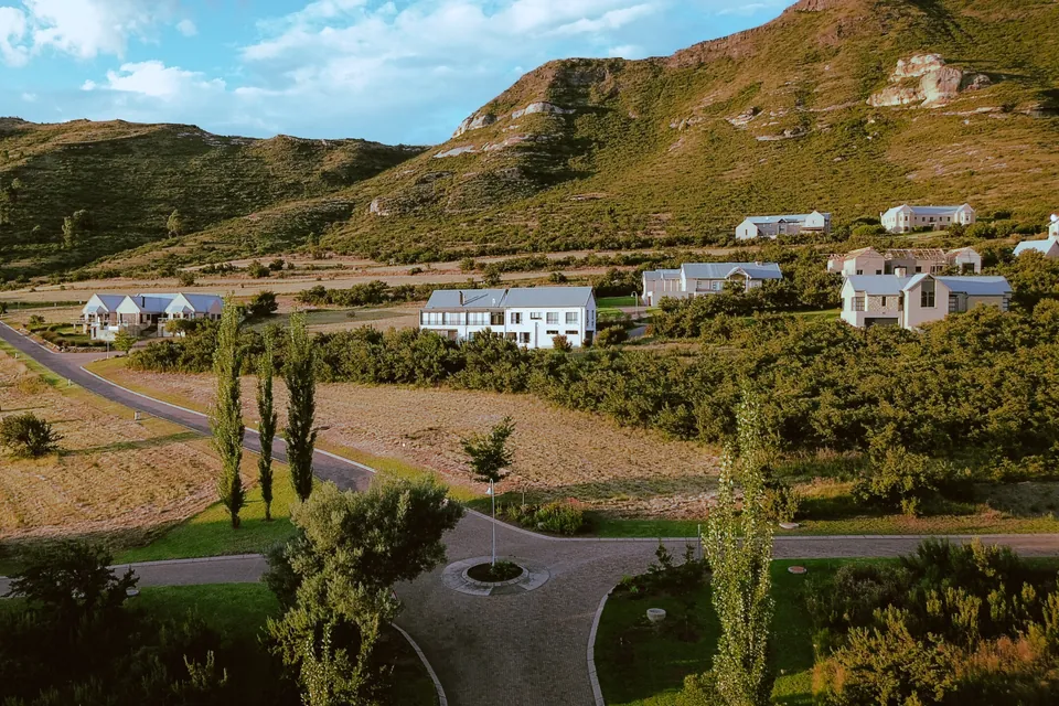 Estate homes beneath the sandstone cliffs