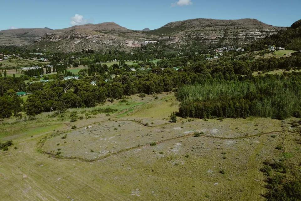 Open estate land below the sandstone cliffs, with stands still to be built on