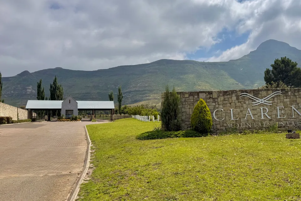 The stone entrance wall to Clarens Mountain Estate beside the access road