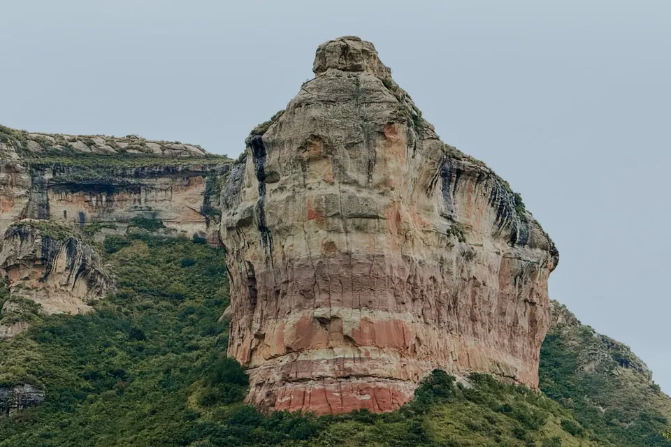 A weathered sandstone buttress against a deep blue sky
